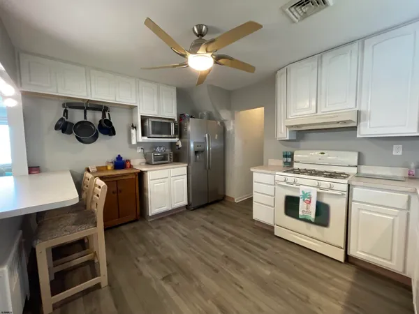 a kitchen with a stove a sink and a refrigerator