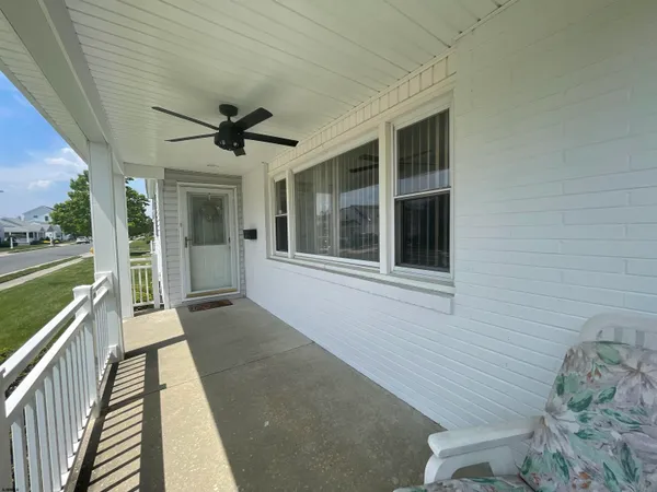 a view of a porch with furniture and garden