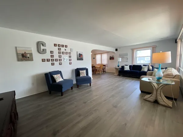 a living room with furniture and a hard wood floor