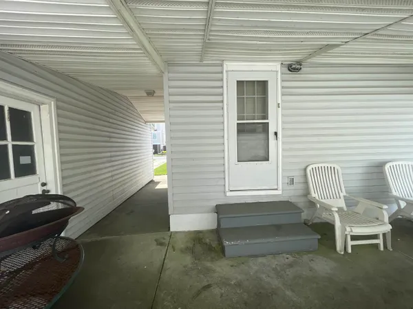 a view of a two chairs in the porch