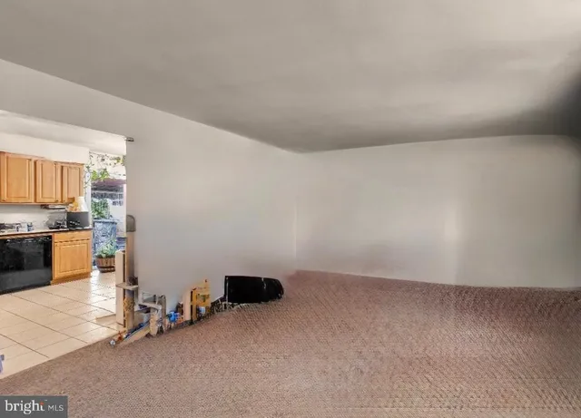 a view of an empty room with kitchen