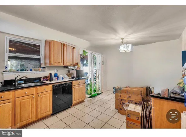 a kitchen with stainless steel appliances granite countertop a stove a sink dishwasher and cabinets with wooden floor