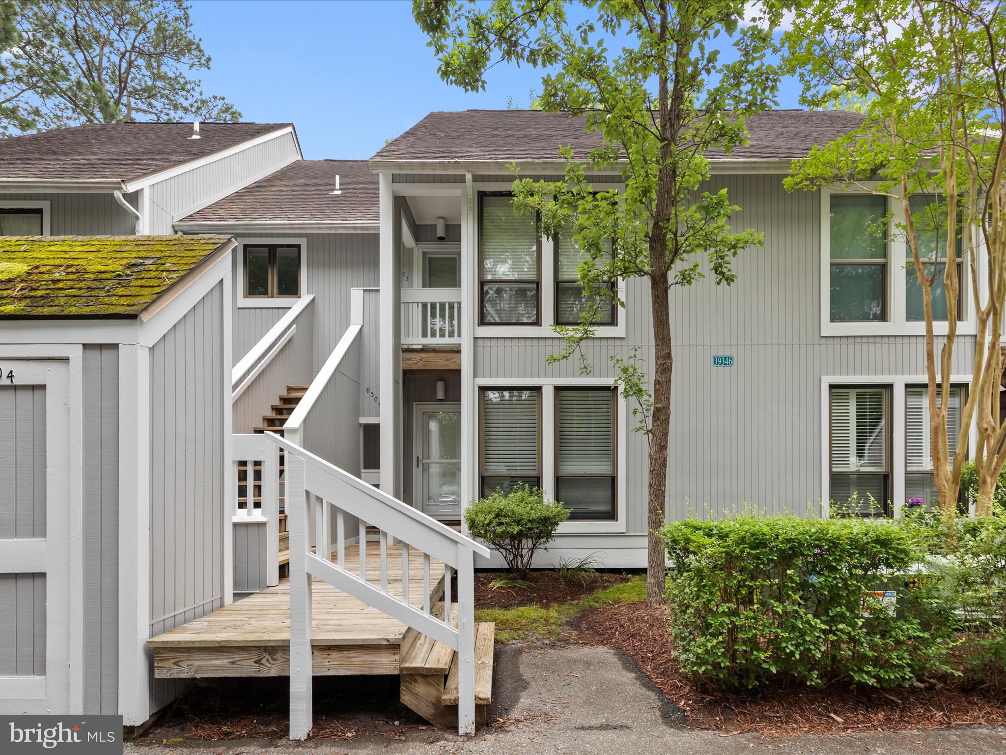 39346 Racquet Lane, Unit 8504 Bethany Beach, DE 19930 - Photo 2 of 40 front view of a house with a porch