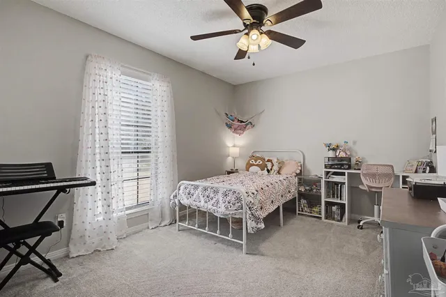a bedroom with furniture and a window
