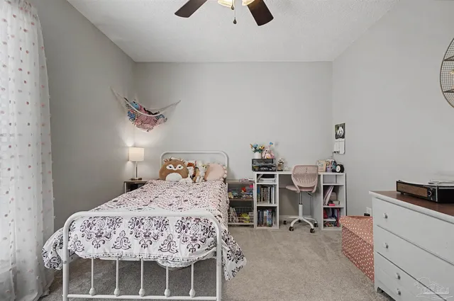 a bedroom with a bed and a chair in it