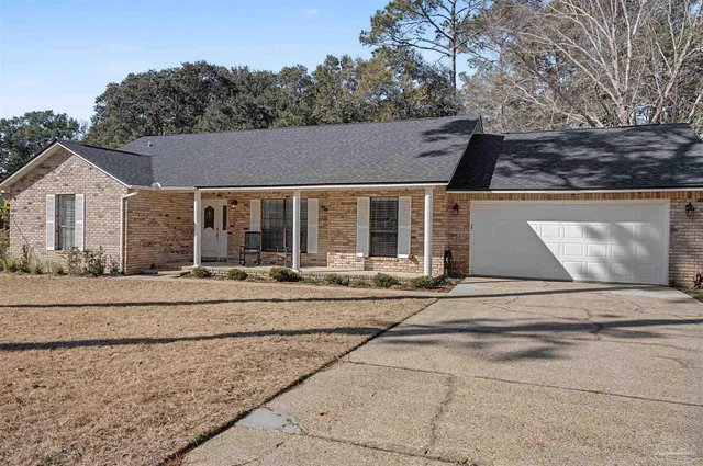 a view of a house with a backyard and porch