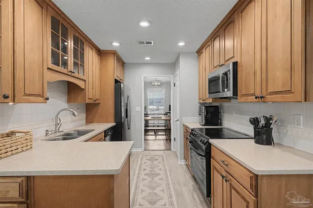 a kitchen that has a sink and a stove top oven