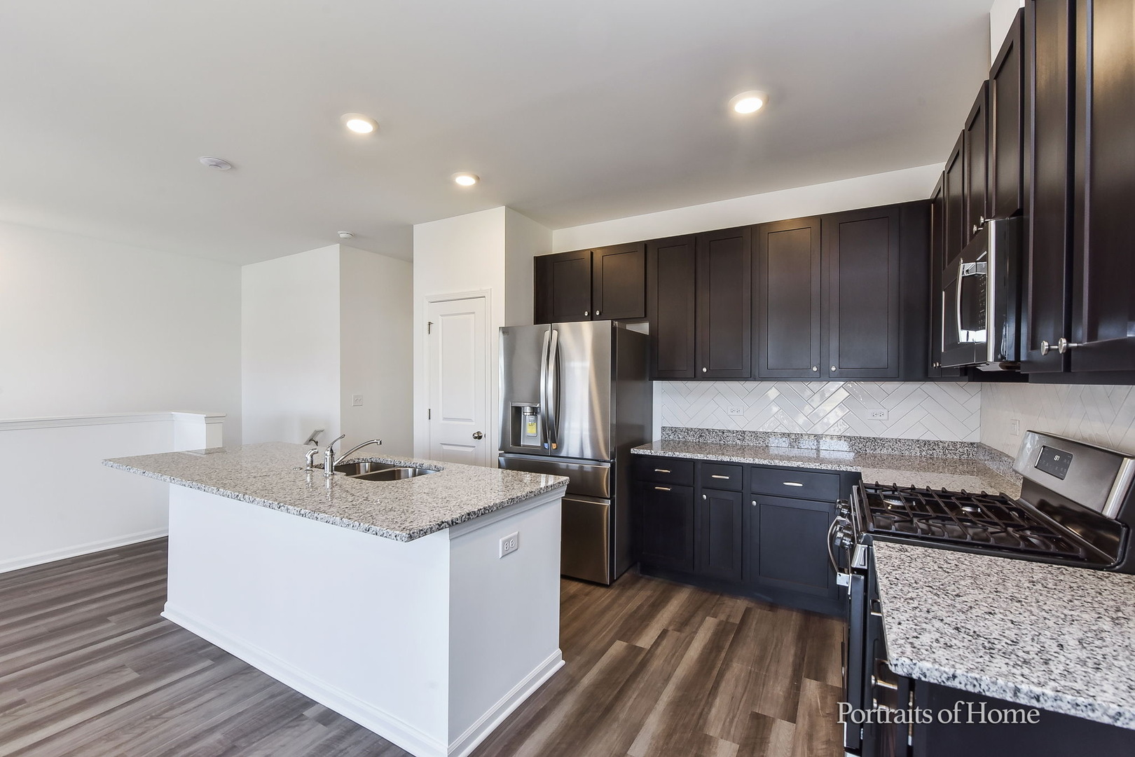 4273 Chelsea Mnr Circle Aurora, IL 60504 - Photo 7 of 23 a kitchen with stainless steel appliances granite countertop a sink stove and refrigerator