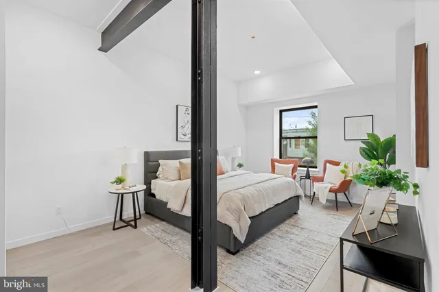 a room with a bed and a potted plant