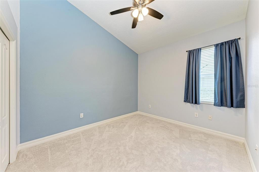 337 Snapdragon Loop Bradenton, FL 34212 - Photo 23 of 54 an empty room with windows and fan