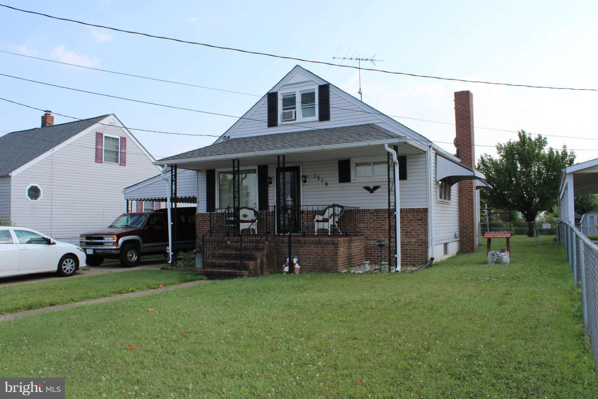 a view of a house with a yard and sitting area
