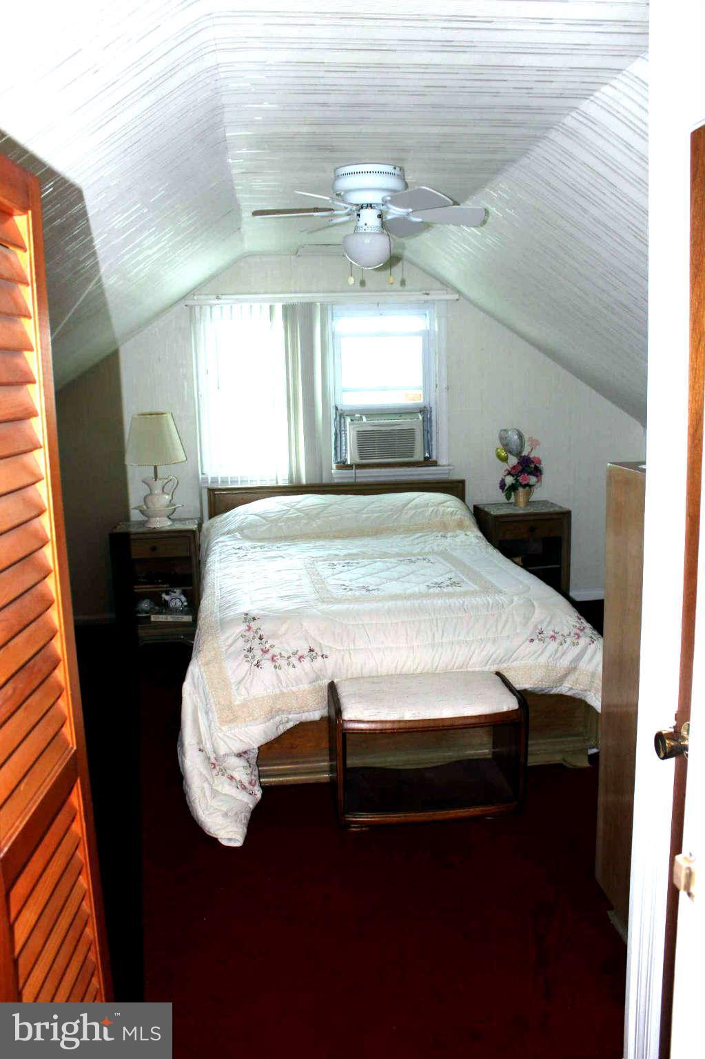 1319 North Point Road Dundalk, MD 21222 - Photo 12 of 24 a bed sitting in a room next to a window