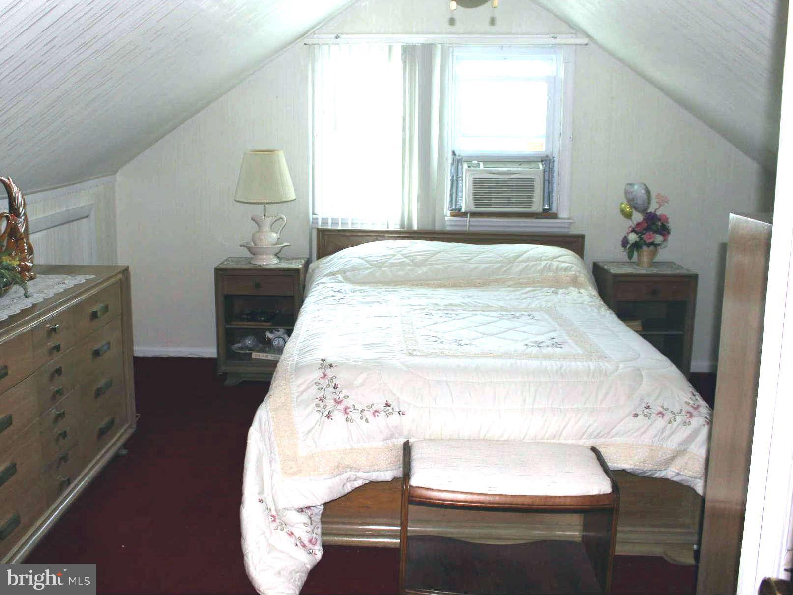 1319 North Point Road Dundalk, MD 21222 - Photo 13 of 24 a spacious bedroom with a bed and a window
