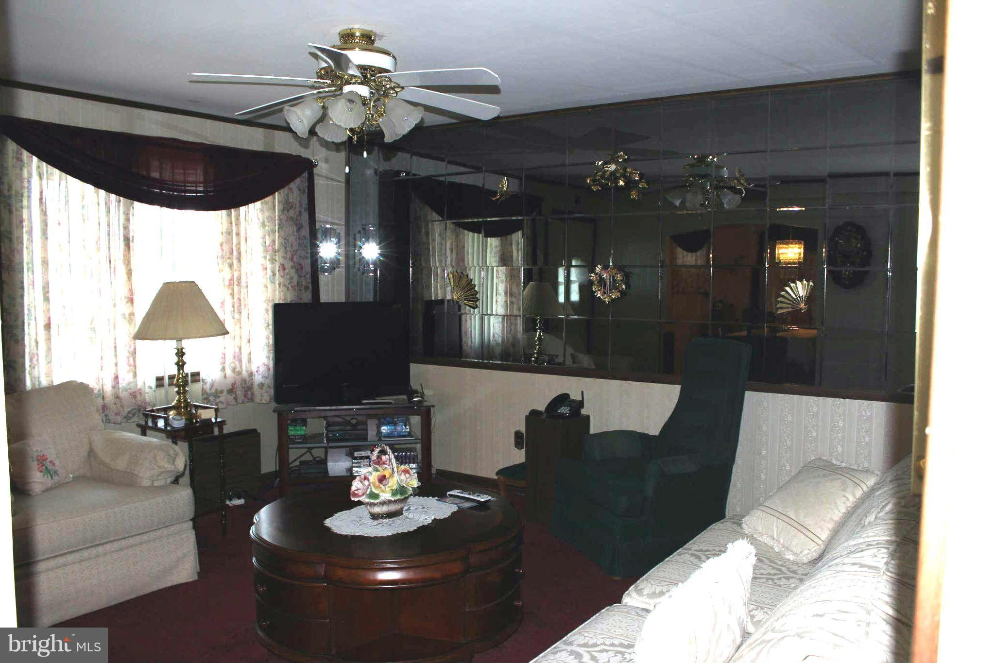 1319 North Point Road Dundalk, MD 21222 - Photo 4 of 24 a living room with furniture and a chandelier