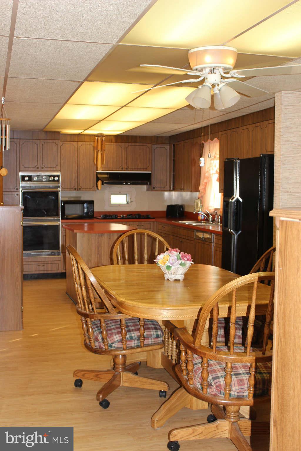 1319 North Point Road Dundalk, MD 21222 - Photo 8 of 24 a kitchen with stainless steel appliances kitchen island granite countertop a sink and cabinets