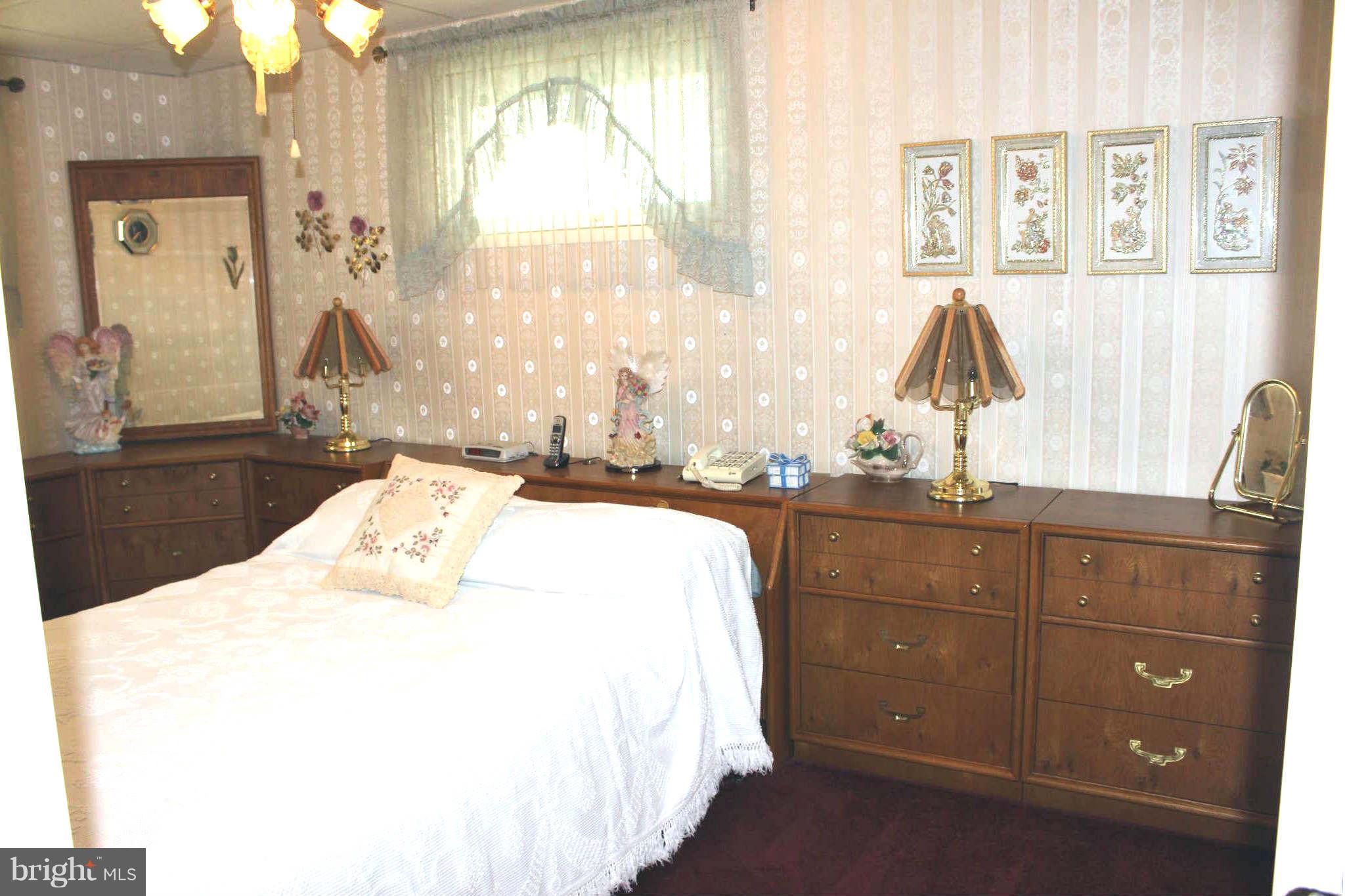 1319 North Point Road Dundalk, MD 21222 - Photo 10 of 24 a bedroom with a bed and large windows