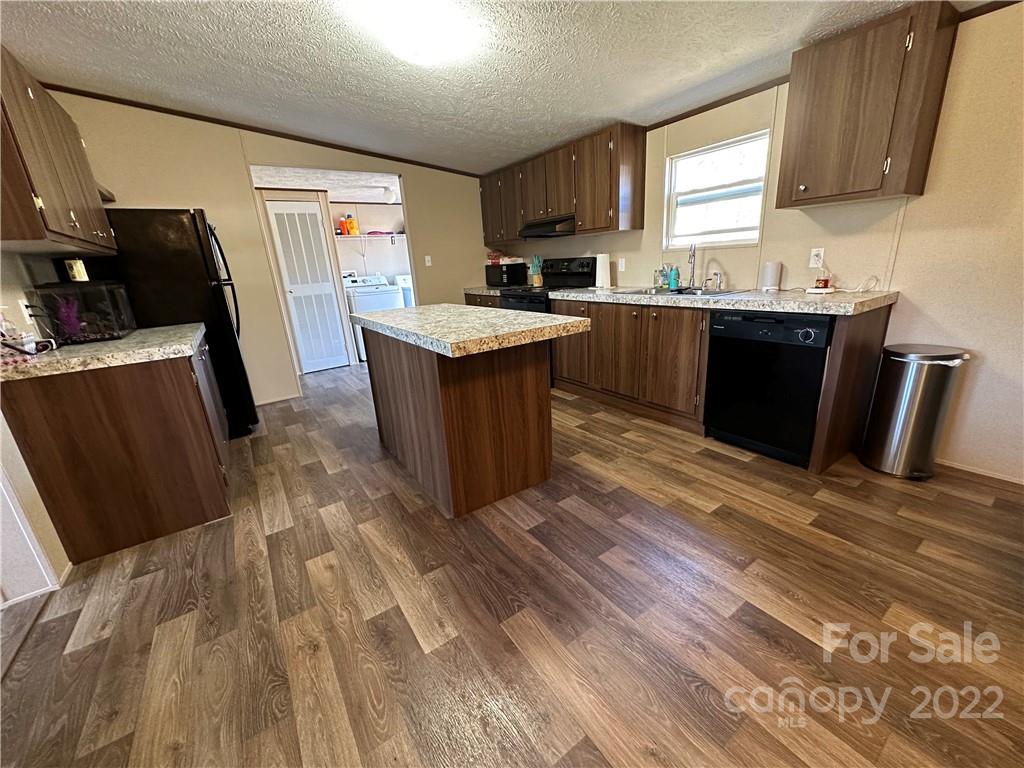 232 Jim Patterson Road Kings Mountain, NC 28086 - Photo 2 of 13 a kitchen with a sink and a refrigerator