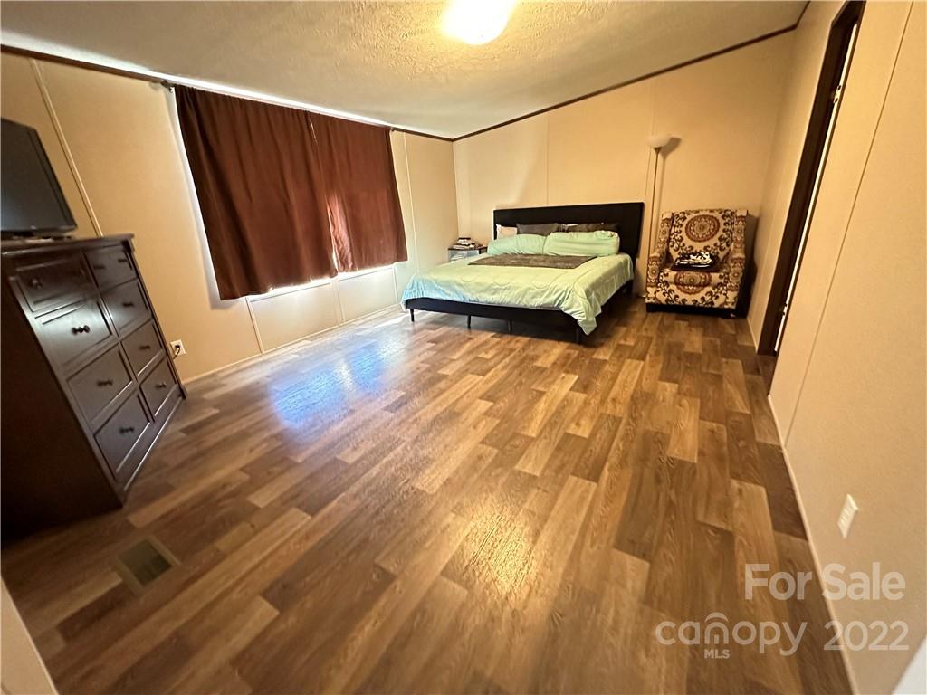 232 Jim Patterson Road Kings Mountain, NC 28086 - Photo 6 of 13 a bedroom with a bed and wooden floor
