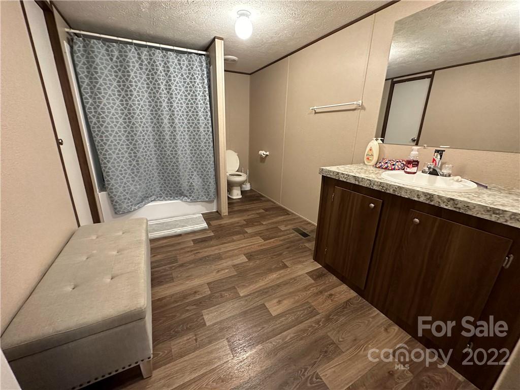 232 Jim Patterson Road Kings Mountain, NC 28086 - Photo 7 of 13 a bathroom with a sink a mirror and a shower