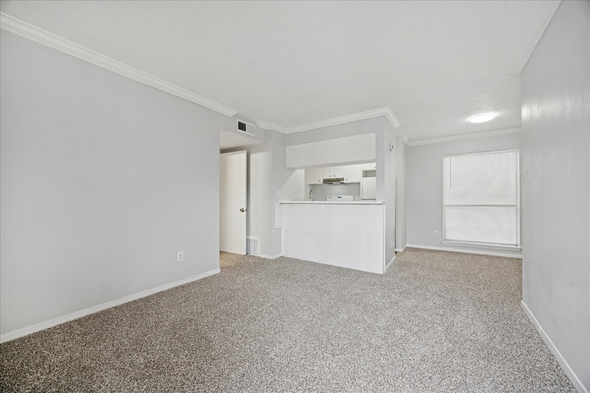 1645 West Main Street, Unit 9 Houston, TX 77006 - Photo 3 of 12 a view of an empty room with a kitchen