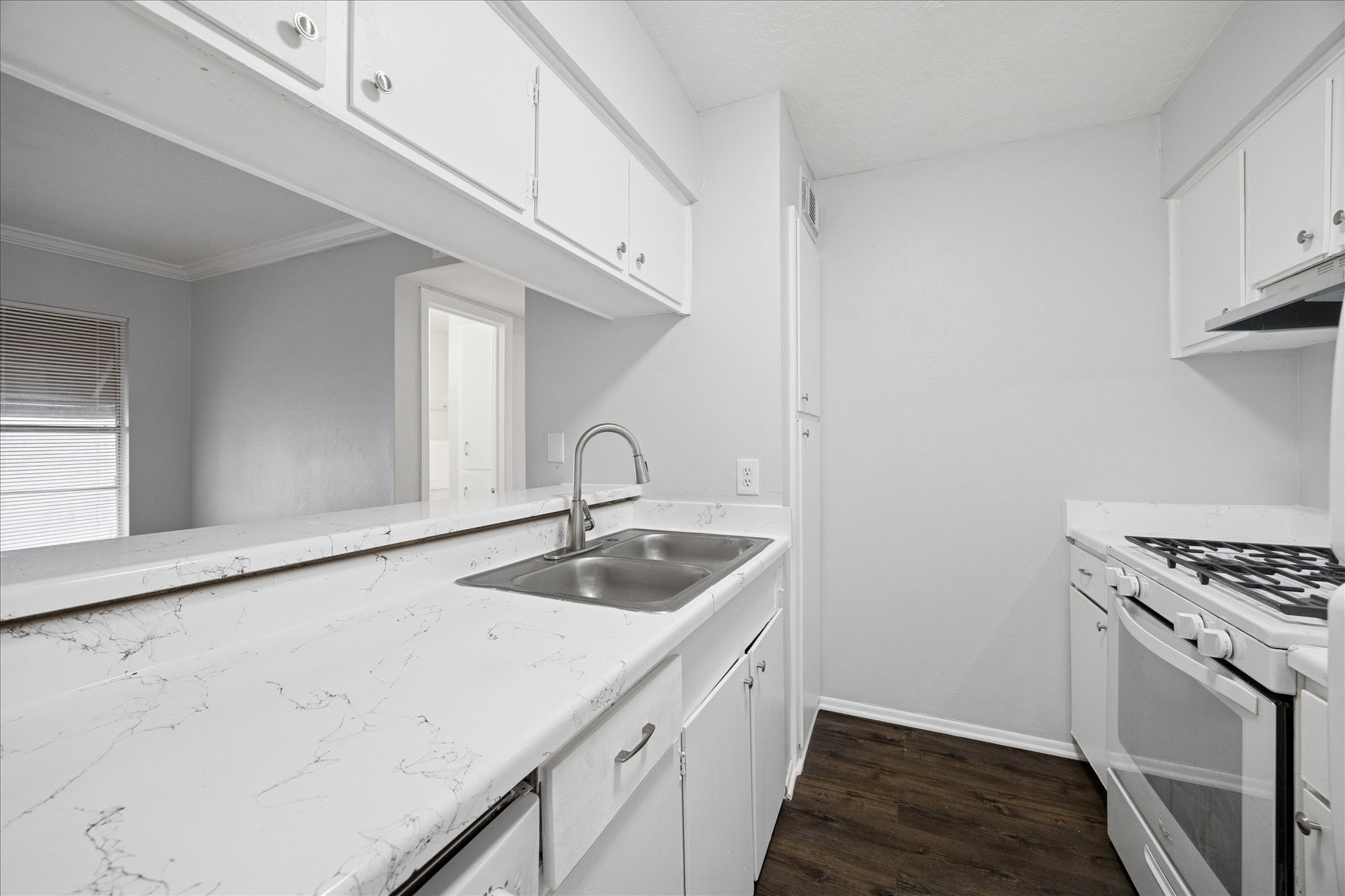 1645 West Main Street, Unit 9 Houston, TX 77006 - Photo 7 of 12 a kitchen with a sink stove and cabinets