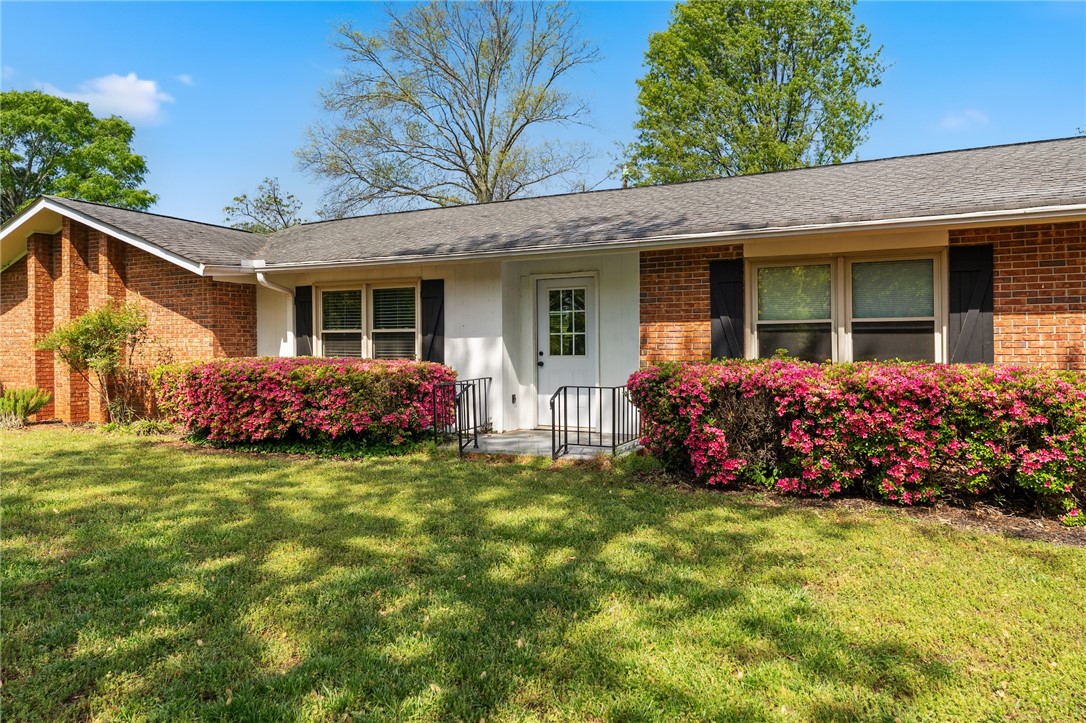 1007 Brown Road Anderson, SC 29621 - Photo 4 of 27 This charming home presents a classic facade with lush, flowering shrubs and a well-maintained lawn.