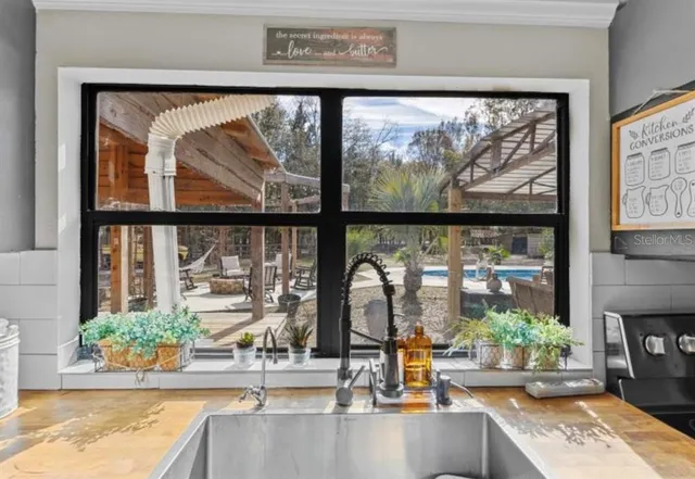 a view of a entryway door with flower in pots