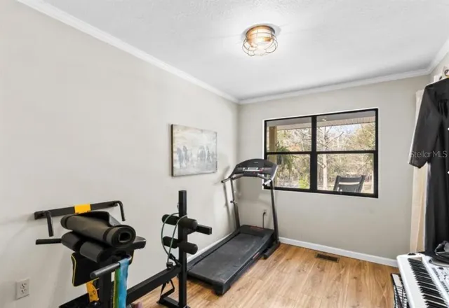 a room with gym equipment and a window