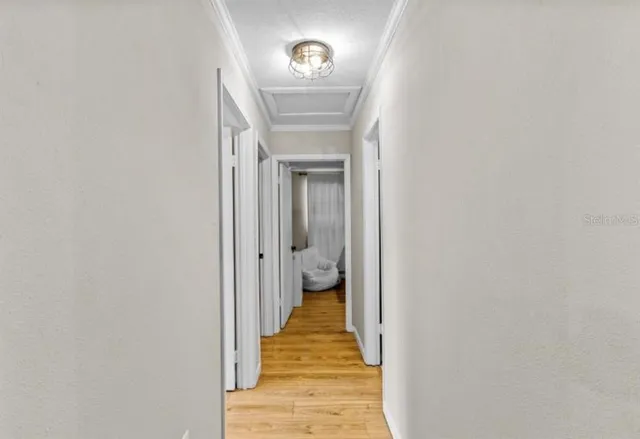 a view of a hallway with wooden floor and a hallway