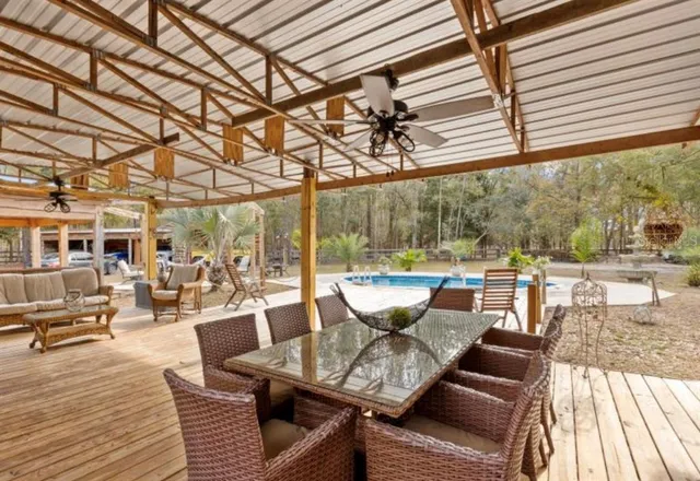 a outdoor space with patio the couches and dining table with wooden floor