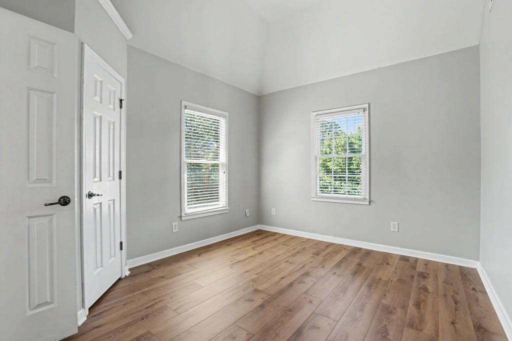 2123 Floral Ridge Drive Dacula, GA 30019 - Photo 40 of 56 an empty room with wooden floor and windows