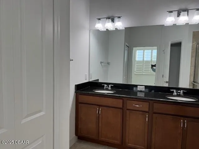 a bathroom with a sink a large mirror and a shower