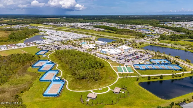 an aerial view of a house with swimming pool and sitting area