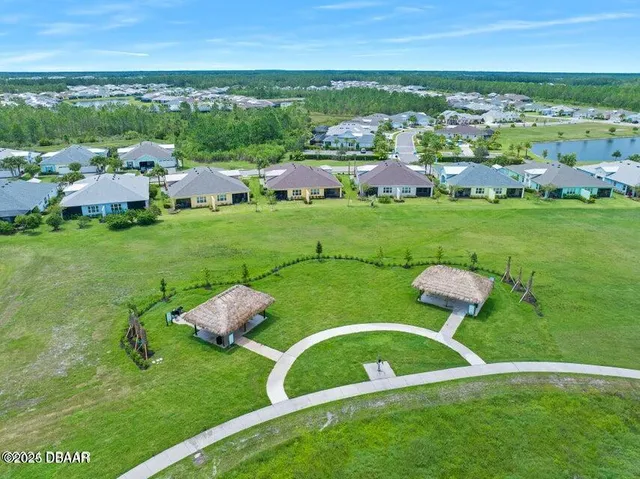 a view of a patio with couches and table and chairs and potted plants
