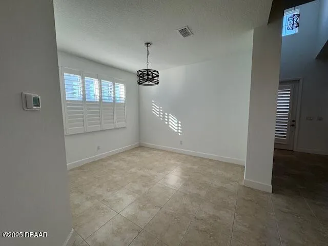 an empty room with a ceiling fan and window