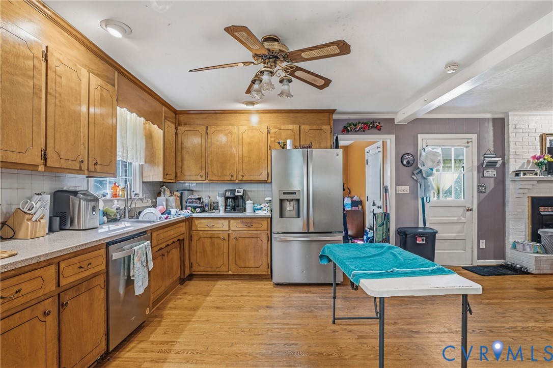 14219 Spruce Avenue Chester, VA 23836 - Photo 12 of 32 a kitchen with stainless steel appliances granite countertop a refrigerator a sink dishwasher and a stove with wooden cabinets
