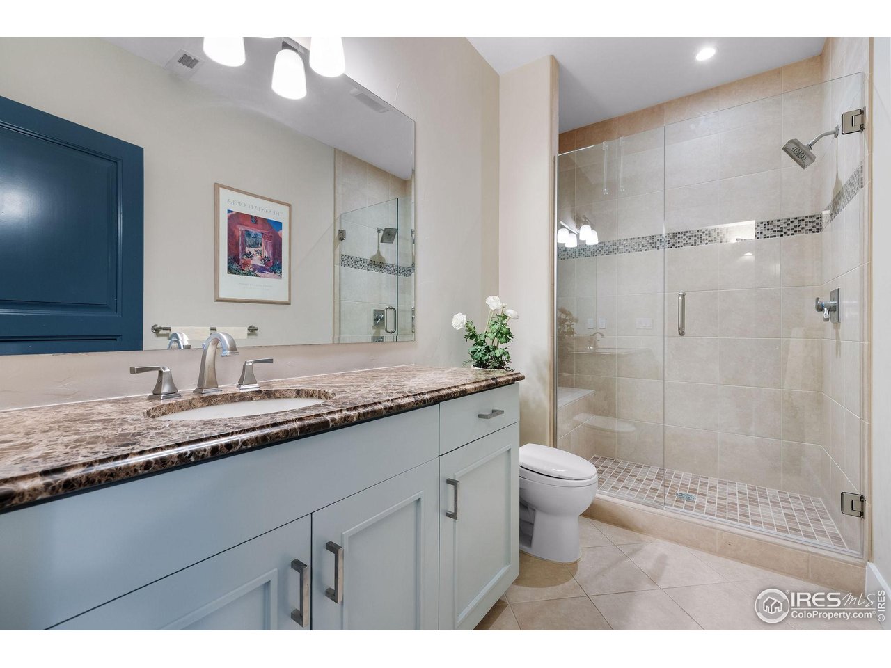 7205 Rustic Trail Boulder, CO 80301 - Photo 43 of 49 a bathroom with a granite countertop sink a toilet a shower and a mirror