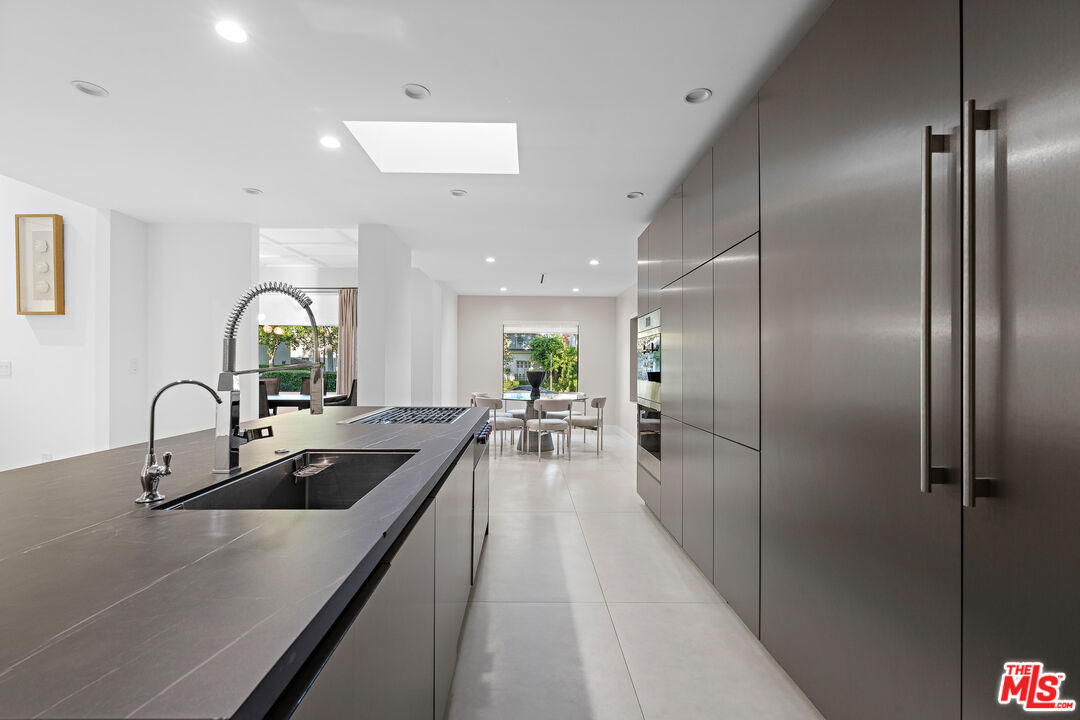201 South Bedford Drive Beverly Hills, CA 90212 - Photo 16 of 37 a kitchen with sink refrigerator and outdoor seating