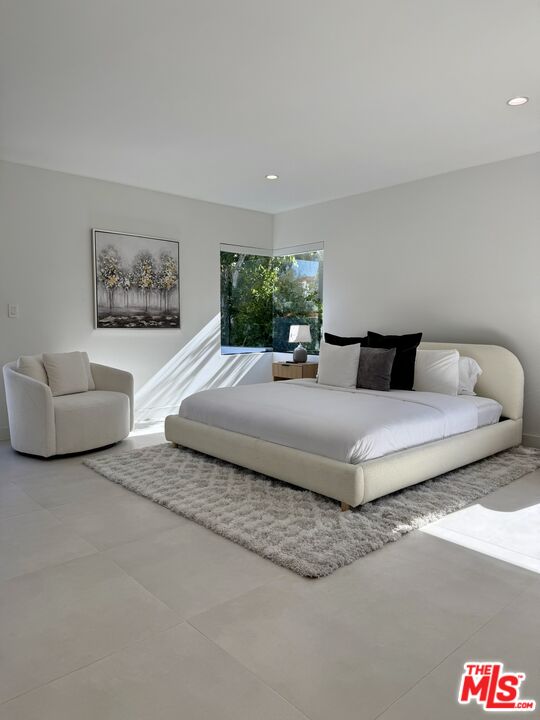 201 South Bedford Drive Beverly Hills, CA 90212 - Photo 19 of 37 a bedroom with a bed and a couch