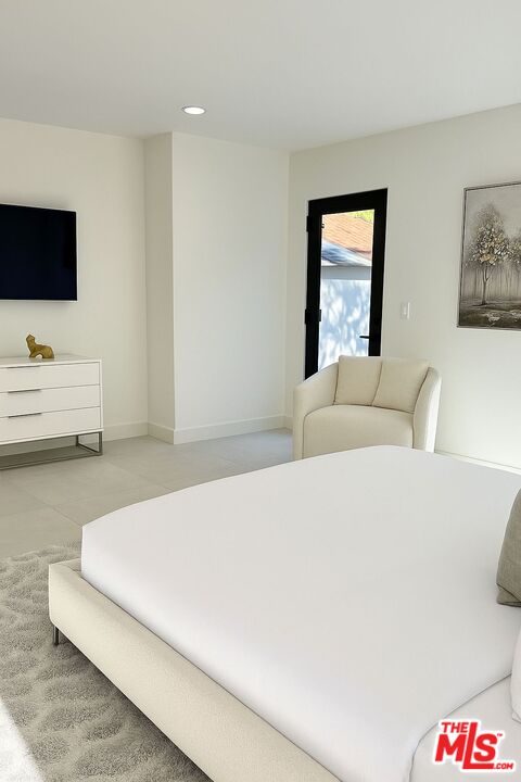 201 South Bedford Drive Beverly Hills, CA 90212 - Photo 21 of 37 a bedroom with a bed and flat screen tv