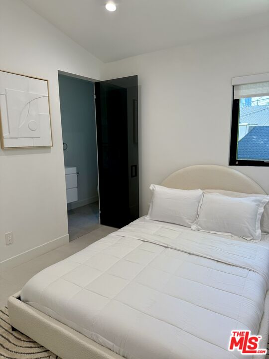 201 South Bedford Drive Beverly Hills, CA 90212 - Photo 22 of 37 a bedroom with a bed and a wall painting