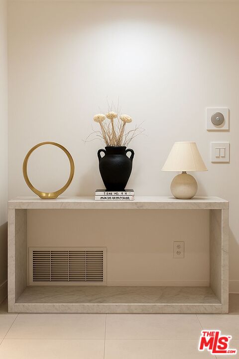 201 South Bedford Drive Beverly Hills, CA 90212 - Photo 26 of 37 a living room with a table and a potted plant