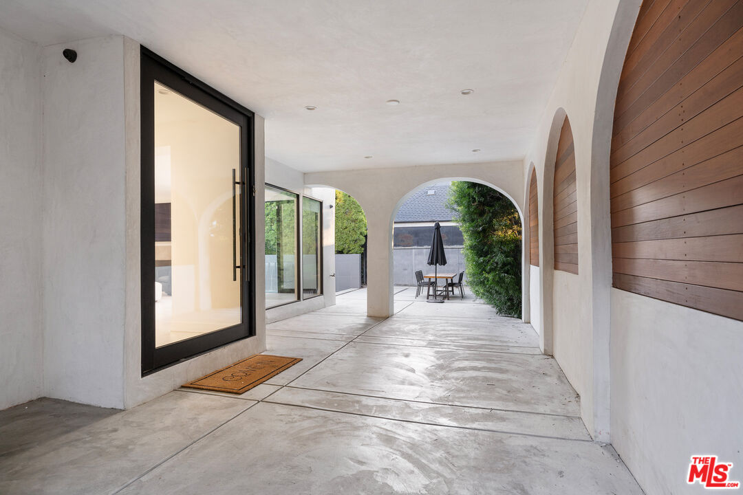 201 South Bedford Drive Beverly Hills, CA 90212 - Photo 28 of 37 a view of a hall with wooden floor and a potted plant