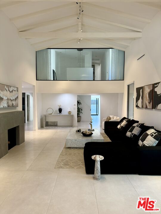 201 South Bedford Drive Beverly Hills, CA 90212 - Photo 3 of 37 a living room with furniture and a mirror