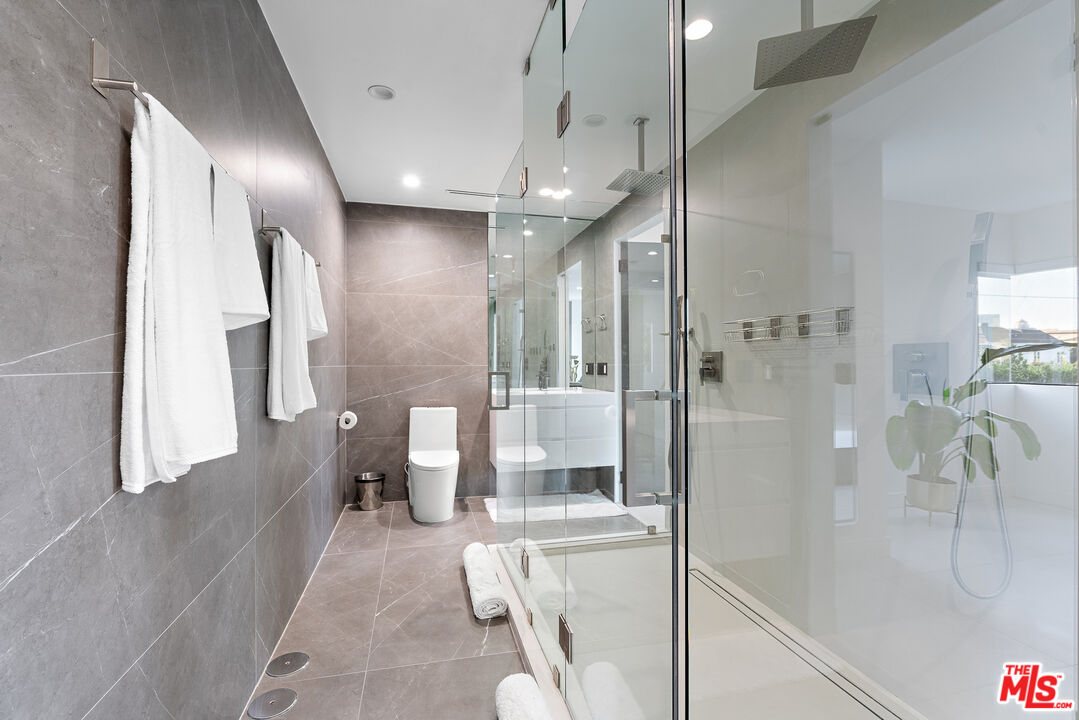 201 South Bedford Drive Beverly Hills, CA 90212 - Photo 33 of 37 a bathroom with a glass shower door