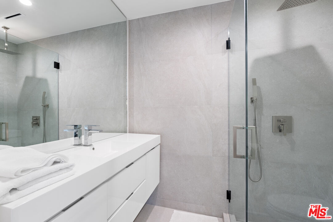 201 South Bedford Drive Beverly Hills, CA 90212 - Photo 34 of 37 a bathroom with a sink and a mirror