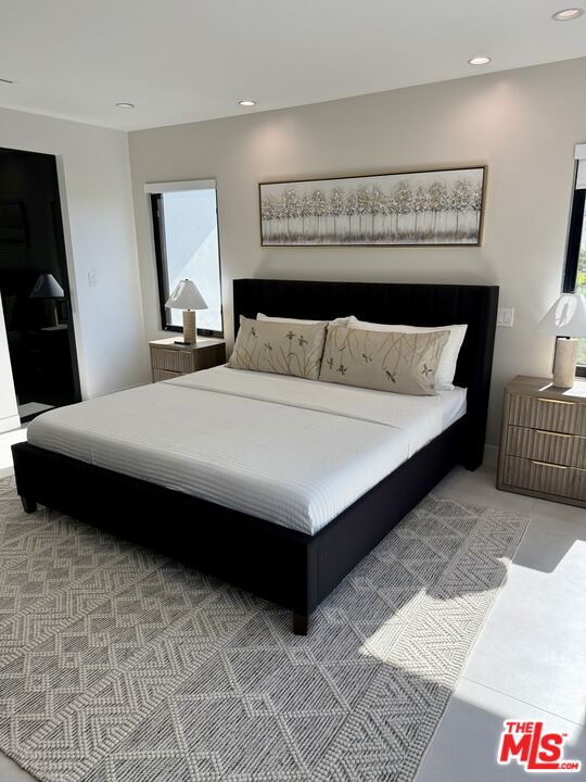 201 South Bedford Drive Beverly Hills, CA 90212 - Photo 5 of 37 a bedroom with a large bed and a couch