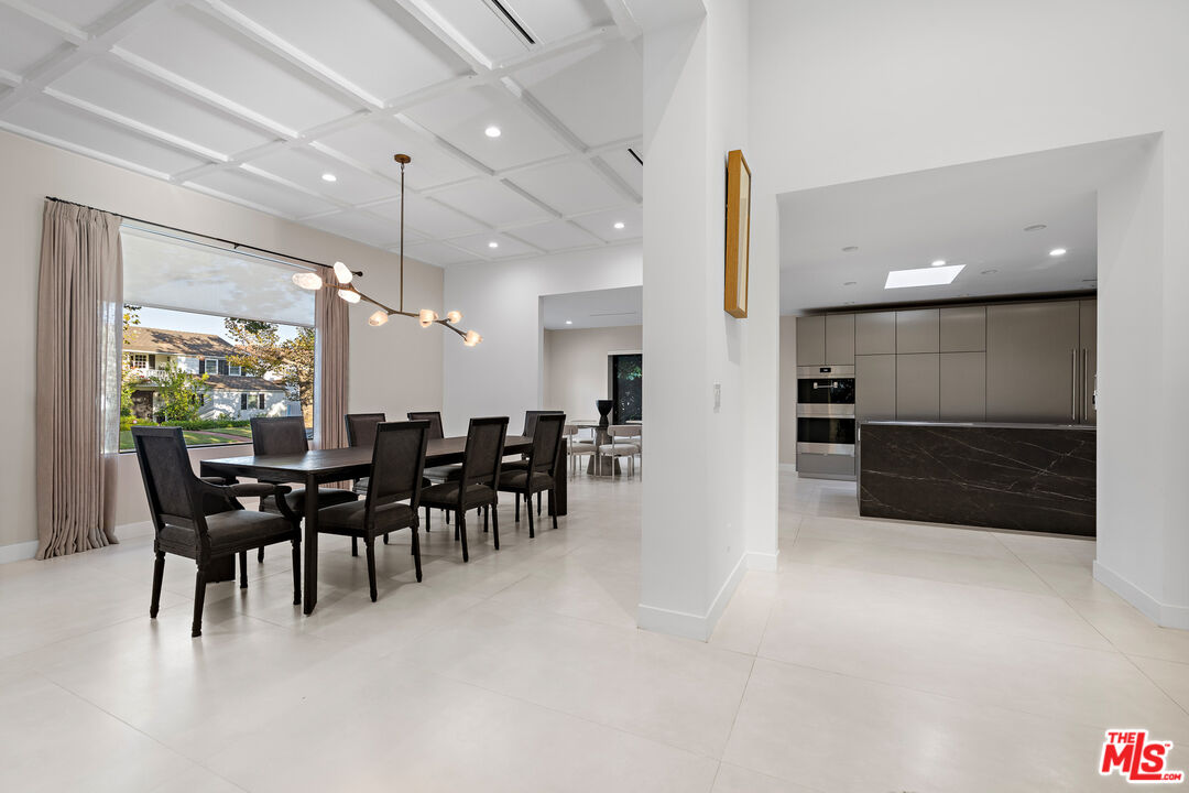 201 South Bedford Drive Beverly Hills, CA 90212 - Photo 7 of 37 a large kitchen with a table and chairs