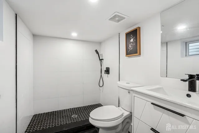 a bathroom with a sink toilet and a mirror