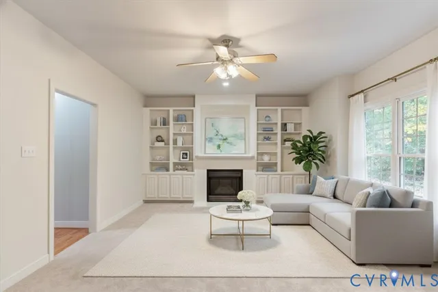 a living room with furniture a fireplace and a large window